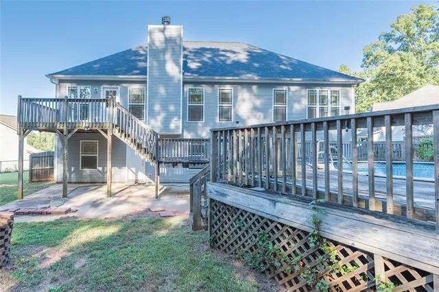 a view of a house with wooden fence