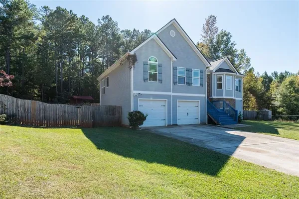 a front view of house with yard and green space