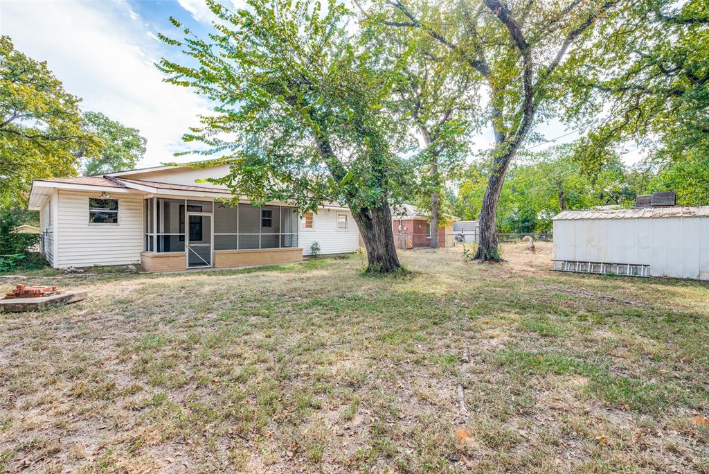 529 Roberts Cut Off Road River Oaks, TX 76114 - Photo 12 of 12 View of yard featuring a sunroom and an outdoor structure