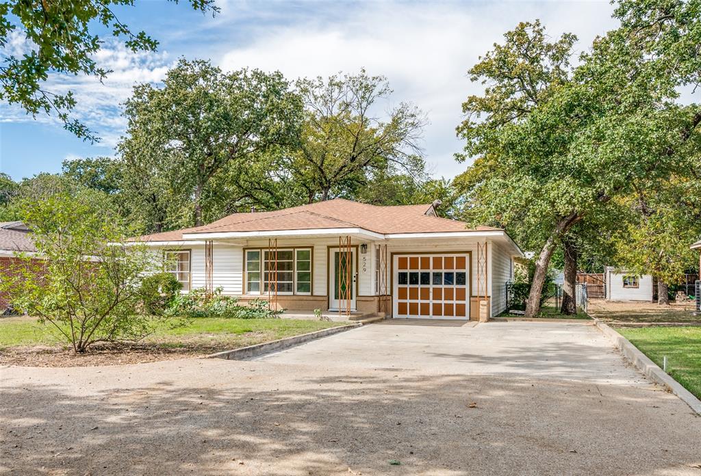529 Roberts Cut Off Road River Oaks, TX 76114 - Photo 2 of 12 View of front facade with an attached garage, concrete driveway, and a shingled roof