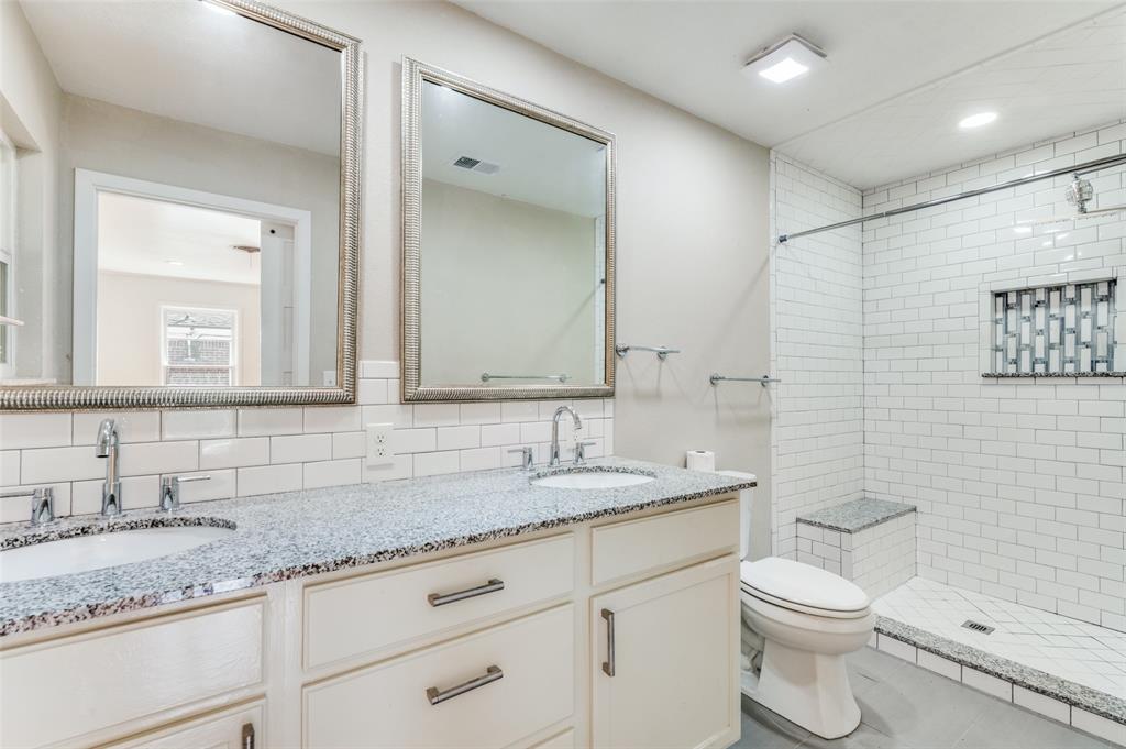 529 Roberts Cut Off Road River Oaks, TX 76114 - Photo 7 of 12 Bathroom featuring double vanity, a shower stall, decorative backsplash, and recessed lighting