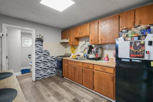 a kitchen with stainless steel appliances a cabinets a sink and a window