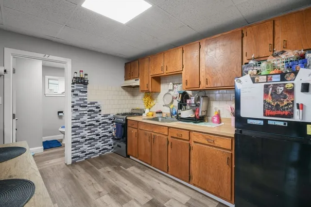 a kitchen with stainless steel appliances a cabinets a sink and a window