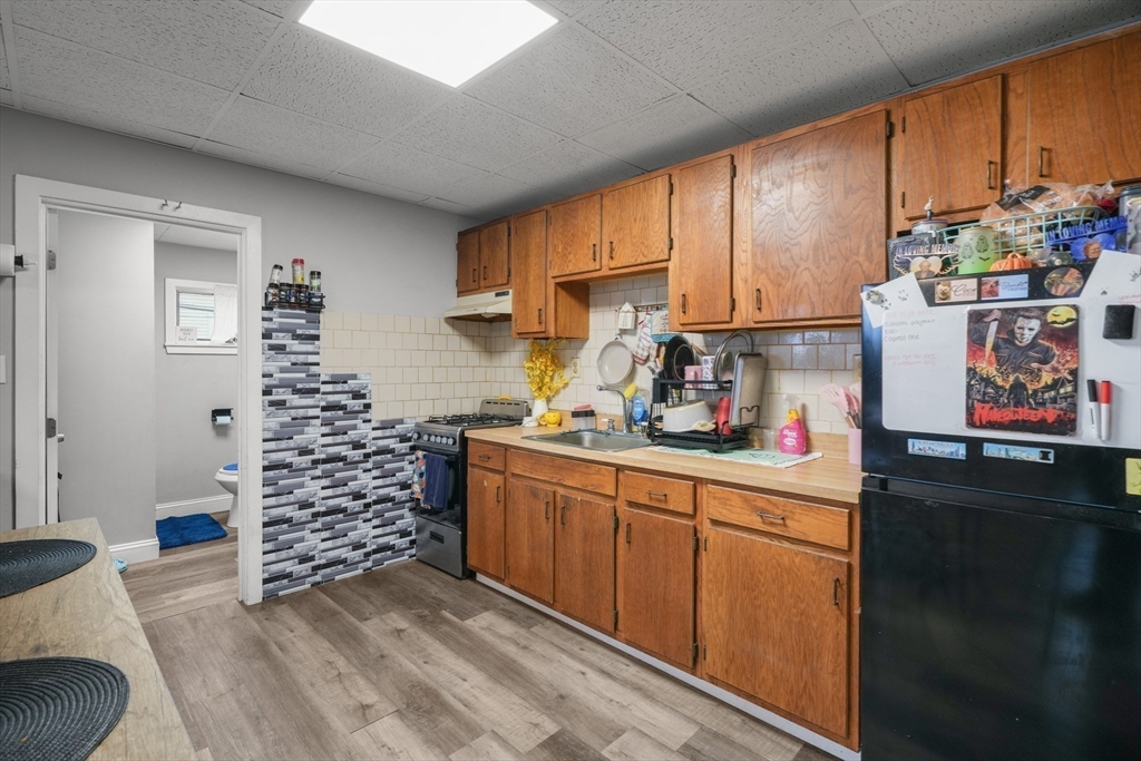 337 Columbia Street Fall River, MA 02721 - Photo 12 of 33 a kitchen with stainless steel appliances a cabinets a sink and a window