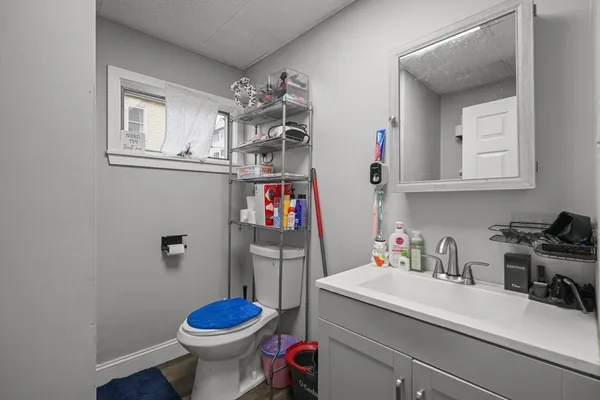 a bathroom with a sink toilet and a mirror