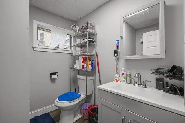 a bathroom with a sink toilet and a mirror