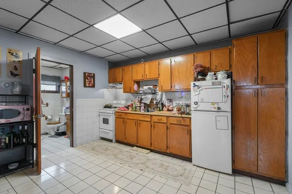 a kitchen with appliances cabinets and furniture