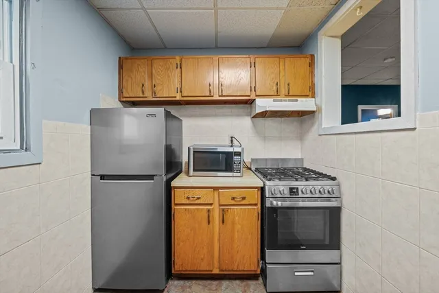 a kitchen with a stove a sink and a microwave