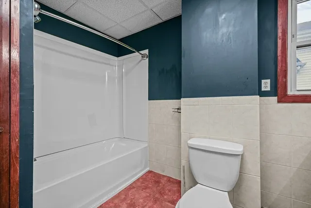 a bathroom with a toilet and a bathtub