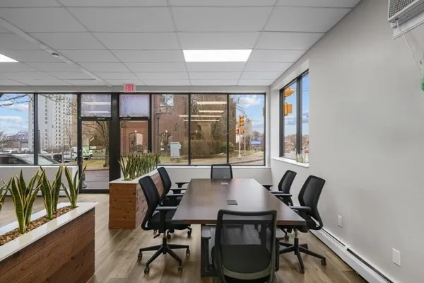 a view of a dining room with furniture large windows and wooden floor