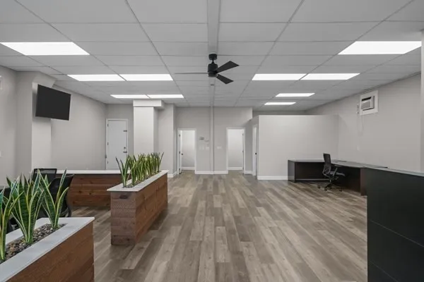a view of a livingroom with a chair and wooden floor