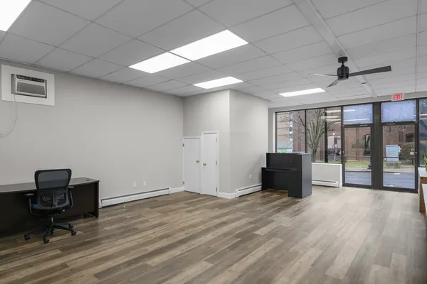 a view of workspace with wooden floor and windows