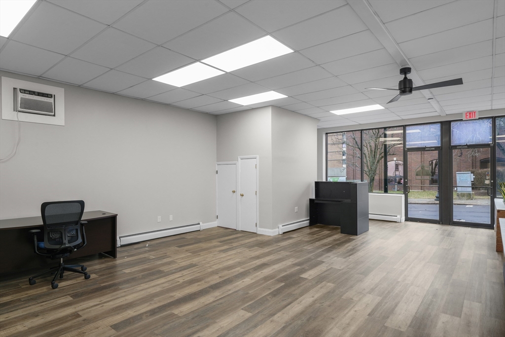 337 Columbia Street Fall River, MA 02721 - Photo 5 of 33 a view of workspace with wooden floor and windows