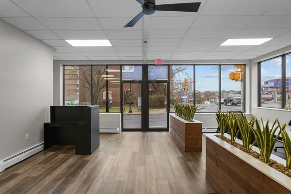 a living room with furniture and large windows