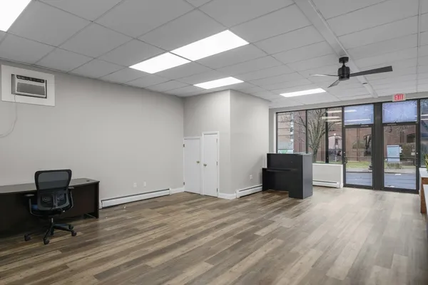 a view of workspace with wooden floor and windows