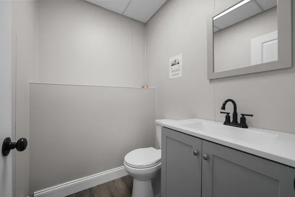 a bathroom with a sink toilet and a mirror