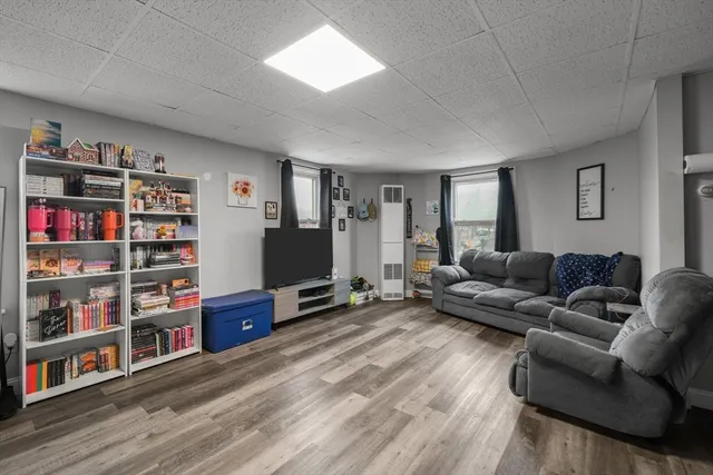 a living room with furniture and a book shelf