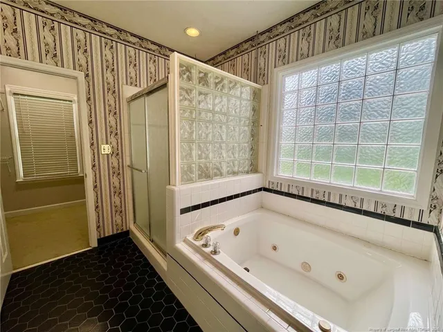 a bathroom with a bathtub and a shower