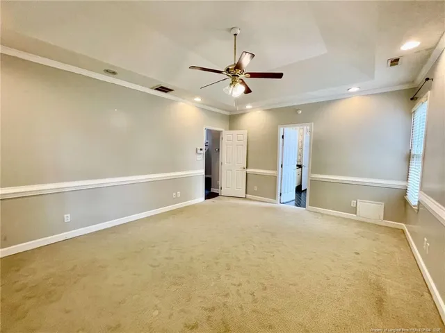 a view of an empty room with a ceiling fan
