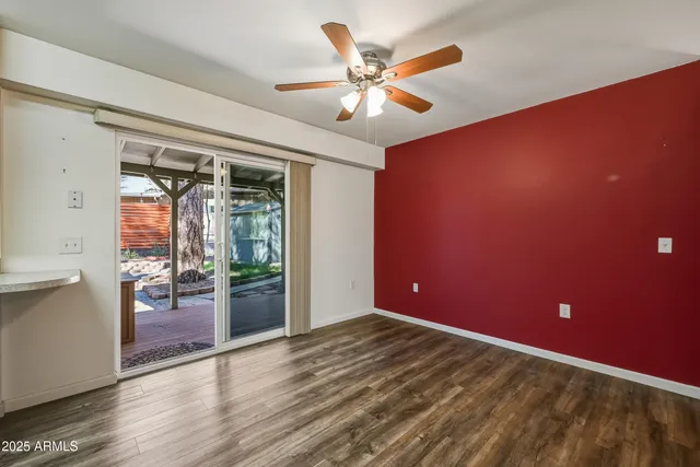 a view of a livingroom with a ceiling fan and window