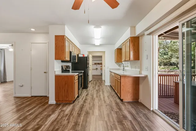 a kitchen with stainless steel appliances kitchen island granite countertop a stove a sink and a refrigerator
