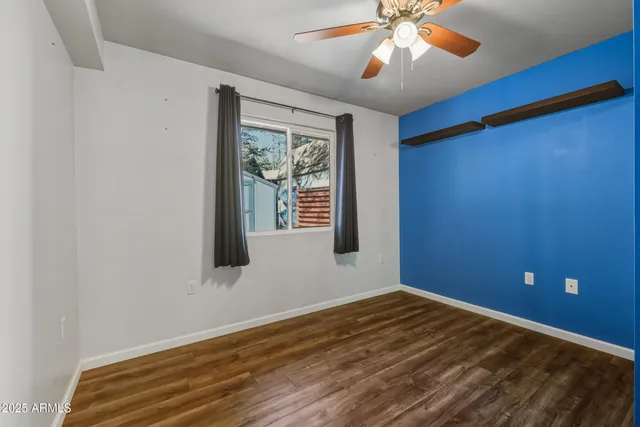 a view of a room with window and ceiling fan