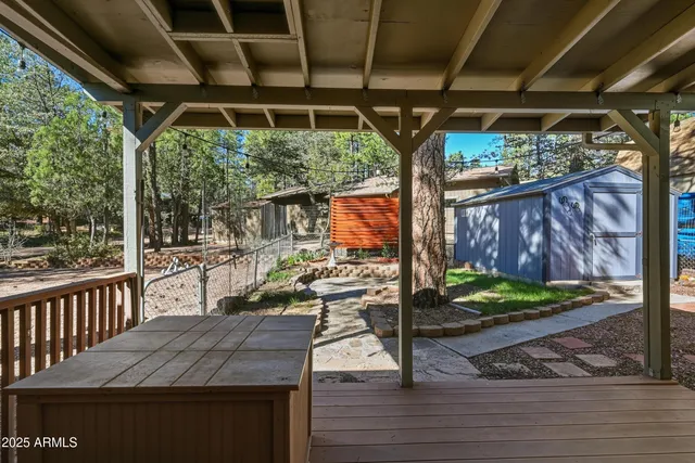 a view of a porch with furniture and a yard