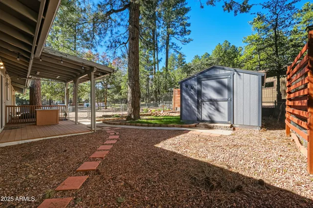 a backyard of a house with barbeque oven fire pit table and chairs