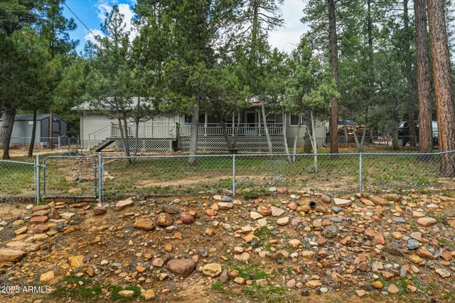 a backyard of a house with swimming pool and outdoor seating