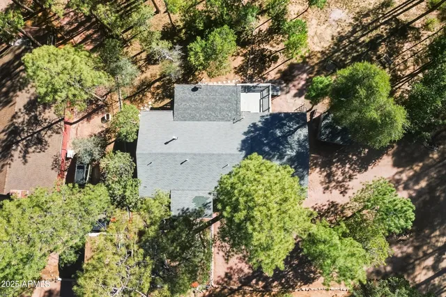 an aerial view of a house with a yard and garden