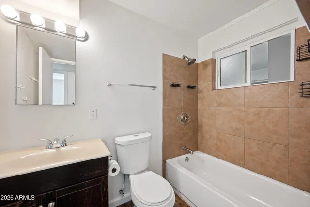 a bathroom with a sink toilet a mirror and shower