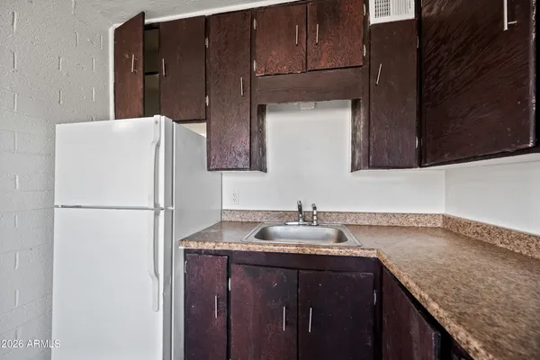 a kitchen with a sink and a refrigerator