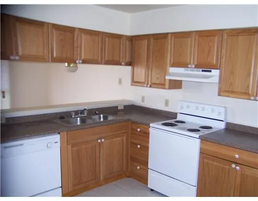 a kitchen with appliances cabinets and a counter top space