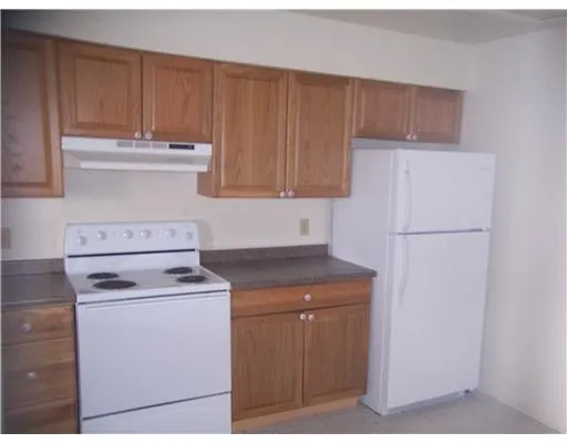 a kitchen with appliances cabinets and a counter top space