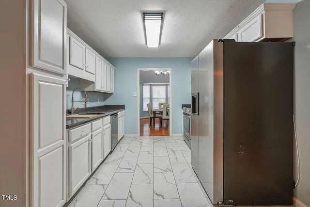 a large kitchen with cabinets and stainless steel appliances