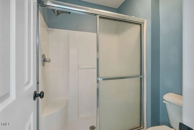 a bathroom with a glass shower door