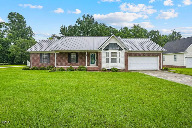 a front view of house with yard and green space