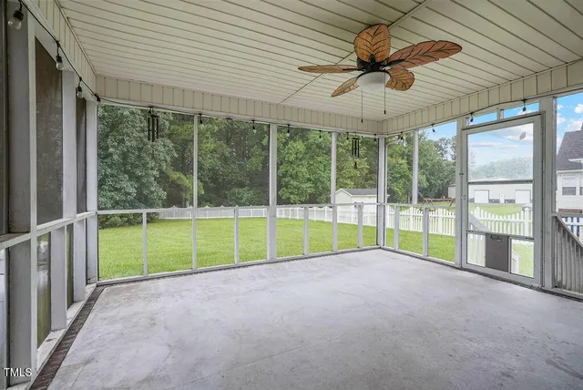 a view of a house with a yard and sitting area