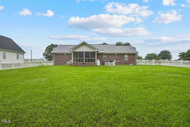 a view of a house with a yard and sitting area