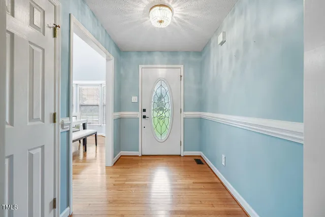 a view of an entryway with wooden floor