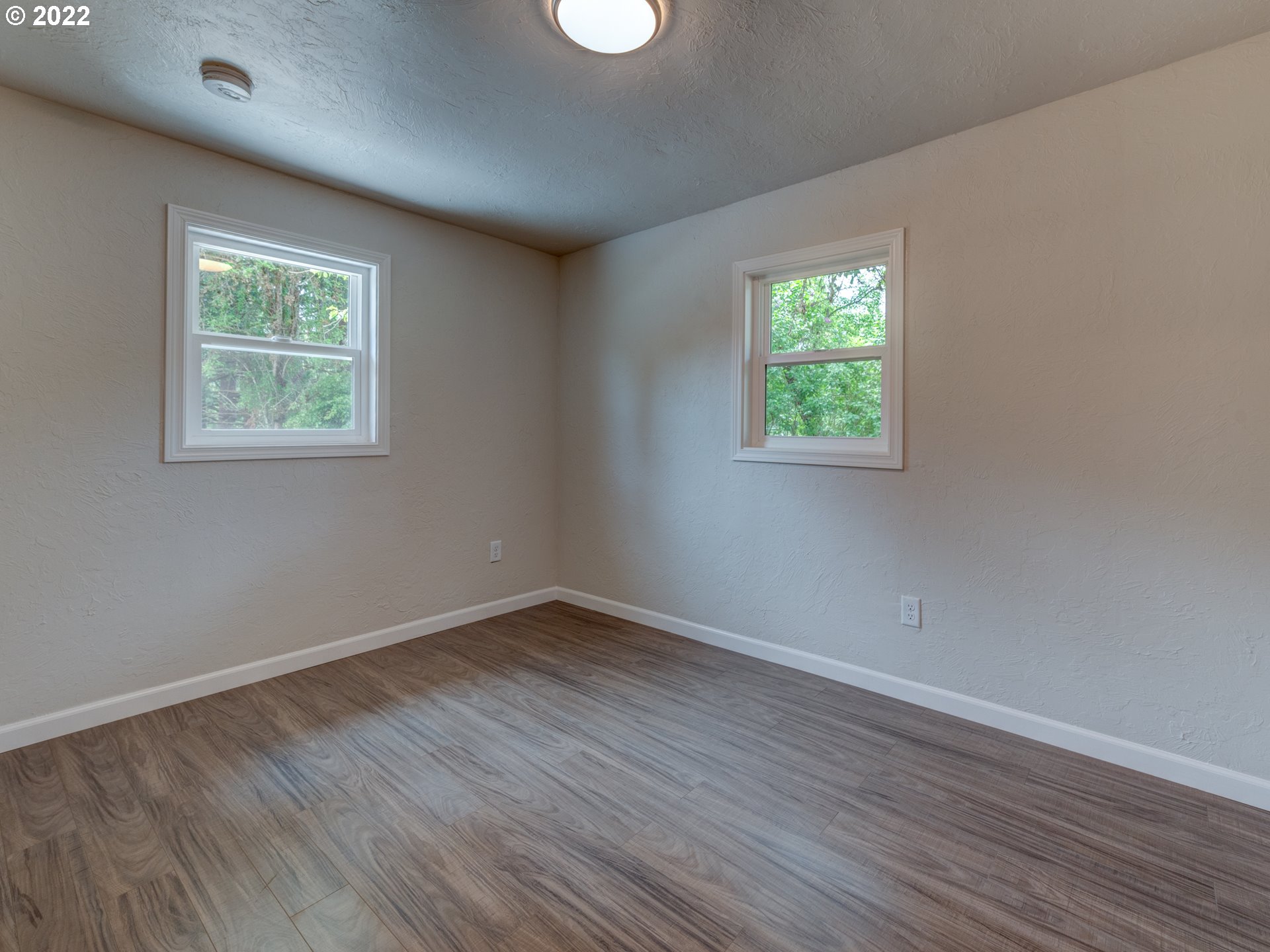 92143 Marcola Road Marcola, OR 97454 - Photo 14 of 27 an empty room with wooden floor and windows