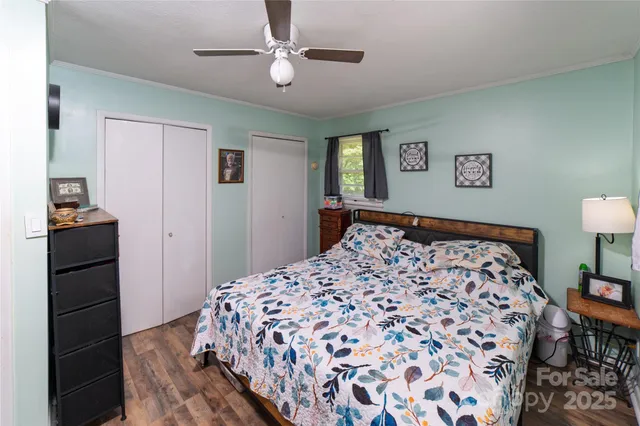 a bedroom with a bed and a lamp on dresser