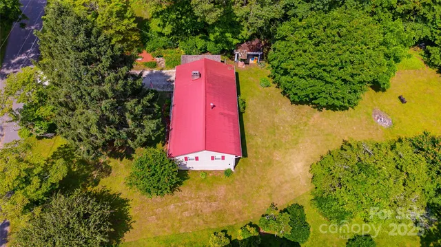 a building view with swimming pool and lawn chairs