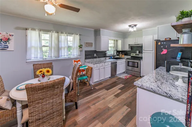 a very nice looking kitchen with granite countertop a stove oven and a refrigerator