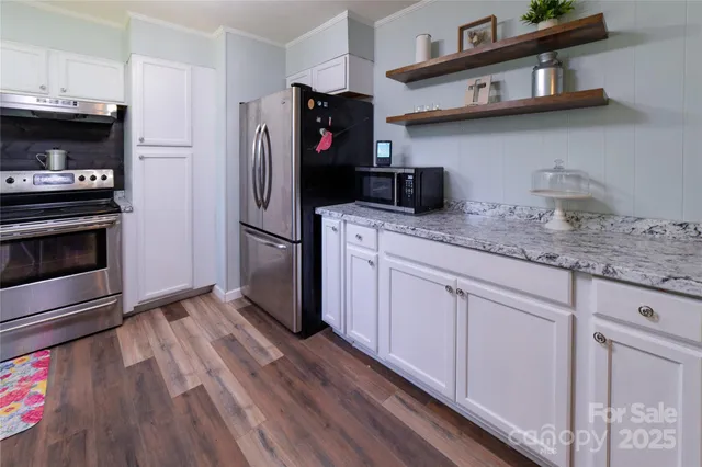 a kitchen with stainless steel appliances a refrigerator and a stove top oven
