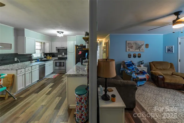 a kitchen with stainless steel appliances granite countertop a stove and a refrigerator