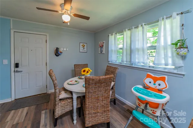a dining room filled with furniture and a window