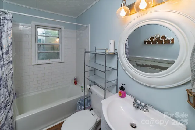 a bathroom with a sink a toilet and bathtub