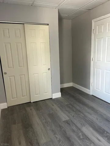 a view of a closet area with hardwood floor