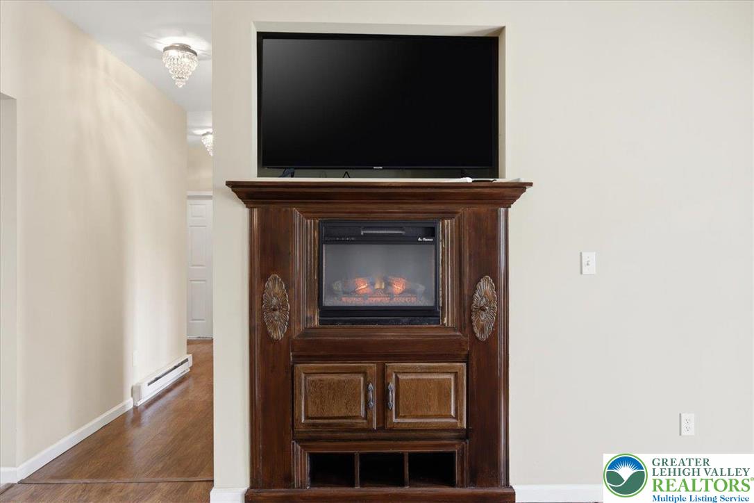 64 Robertson Road Jim Thorpe, PA 18229 - Photo 14 of 54 a living room with a fireplace and a flat screen tv